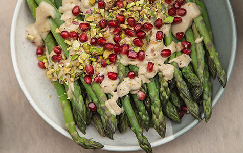 Cooked,Asparagus,With,Tahini,Sauce,,Pistachios,And,Pomegranate,,Top,View.